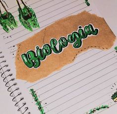 an open notebook with the word bologna written in green ink on top of lined paper