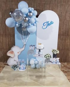 a table with balloons and decorations for a baby shower