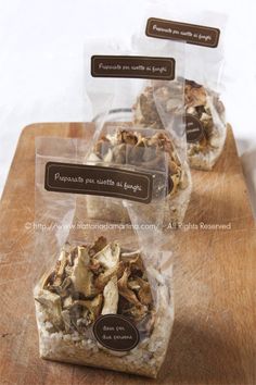 three bags of food sitting on top of a wooden table