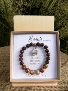 The Bronzite gemstone energy bracelet with its Om silver charm will bring HARMONY and inspires bravery, certainty and protection in your life. This dual-powered bracelet brings both transformation and grounding, with the added properties of Picture Jasper. Each INSPIRIT bracelet symbolizes a unique theme or lesson. Bronzite restores harmony and inner peace, alleviating feelings of self-doubt, boosting self-confidence and decisiveness and infusing the spirit with the courage to follow through on Bronzite Bracelet, Energy Bracelets, Les Chakras, Les Sentiments, Picture Jasper, Self Confidence, Inner Peace, Silver Charms, Arm Band