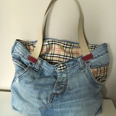 a handbag made out of old jeans is sitting on top of a white table