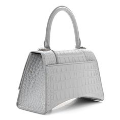 This is an authentic BALENCIAGA Shiny Calfskin Crocodile Embossed Small Hourglass Top Handle Bag in Steel Grey. This stylish petite handbag is beautifully crafted of crocodile stamped glazed calfskin in grey. It features a top handle, an optional shoulder strap and aged silver hardware. The front flap opens to a grey leather interior with a zipper pocket. Bag Outfit, Womens Designer Bags, Fancy Bags, Fame Dr, Balenciaga Bag, Colour Board, Grey Colour, Tk Maxx, Luxury Accessories