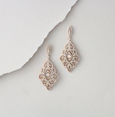 "Sparkly Rose Gold finish earrings are set with Swarovski Pure Brilliance stones in a vintage filigree design. You will fall in love with these beauties ! Available in rose gold, yellow gold and rhodium finish Earrings measure 2.25\" L x 1\" W Matching bracelet: https://www.etsy.com/listing/495588441/rose-gold-bracelet-wedding-jewelry?ref=listing-shop-header-0 https://www.etsy.com/listing/674474135/rose-gold-bridal-bracelet-teardrop?ref=shop_home_active_1&pro=1&frs=1" Elegant Filigree Earrings In Cubic Zirconia, Exquisite Pierced Bridal Earrings, Ornate Wedding Diamond Drop Earrings, Exquisite Wedding Earrings With Intricate Design, Cubic Zirconia Chandelier Earrings With Intricate Design As Gift, Intricate Cubic Zirconia Chandelier Earrings As Gift, Gold Bridal Earrings With Intricate Cubic Zirconia Design, Gift Cubic Zirconia Chandelier Earrings With Intricate Design, Elegant Filigree Wedding Earrings