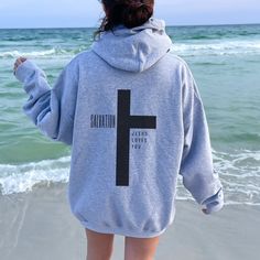 "Faith-Inspired Jesus Loves You Hoodie - a warm and comforting addition to your wardrobe that beautifully combines faith and style. This cozy sweatshirt bears the heartwarming message, \"Jesus Loves You,\" serving as a powerful reminder of the boundless love that Jesus has for you and all who believe in Him. In addition to this inspiring message, the hoodie features a Christian cross, symbolizing the ultimate sacrifice and salvation that Jesus brought to the world.  This Christian hoodie is perf Jesus Loves You Hoodie, Christian Hoodies Aesthetic, Love Like Jesus Shirt, Jesus Sweaters, Cute Hoodie Designs, Christian Sweatshirt Designs, Jesus Hoodies, Jesus Sweater, Loves You