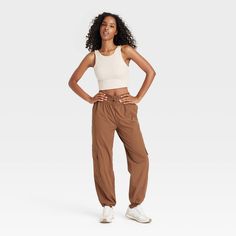 Level up your athleisure wardrobe with these Mid-Rise Woven Cinched Pants from JoyLab™. Made of nylon with added spandex, these mid-rise pants feature front elastic for easy movement. Tailored in athletic fit, these pull-on pants are easy to wear and pair well with crop tops, tees and sweatshirts. JoyLab™: A movement that’s always in motion. Casual High Waist Nylon Yoga Pants, Sporty Stretch Cargo Pants For Summer, Spring Sportswear Parachute Pants, Casual Stretch Mid-rise Parachute Pants, Fitted Mid-rise Sporty Cargo Pants, Fitted High Waist Joggers In Athleisure Style, Sporty Stretch Parachute Pants For Spring, Spring Stretch Sporty Parachute Pants, Sports Nylon Sweatpants