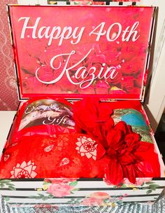 an open box with red flowers on it and the words happy 40th kasija written in white