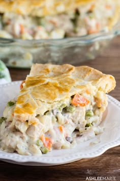 a slice of chicken pot pie on a plate next to a casserole dish