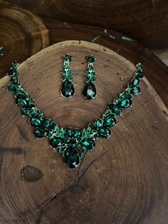 "Emerald necklace set with drop cluster crystal rhinestone necklace and earrings set are a great statement piece!  Size of earrings: 1.75\" Long.  Style: pierced and clip on available! Necklace 17\"long with 2.5\" chain extender Decor Dangle Size: 1.5\" drop width  Color: emerald green Base metal color: silver More colors available upon request, just message us! Need a matching bracelet to complete your look?  https://www.etsy.com/listing/1642297157/emerald-rhinestone-bridal-bracelet?click_key=6d0bb6f568dbf21a2dc7d909e9f1a2facb8c8779%3A1642297157&click_sum=431a0c11&ga_search_query=emerald&ref=shop_items_search_5&frs=1&sts=1 https://www.etsy.com/listing/621708283/emerald-bracelet-emerald-rhinestone?ref=shop_home_active_29&frs=1 https://www.etsy.com/listing/562630232/emerald-rhinestone-brace Emerald Jewelry Necklaces, Green Crystal Jewelry, Green Crystal Jewelry With Jeweled Details, Green Crystal Jewelry For Party, Formal Green Jeweled Jewelry Sets, Green Dangle Jewelry For Evening, Green Dangle Evening Jewelry, Green Crystal Jewelry For Evening, Green Jewelry Sets For Evening