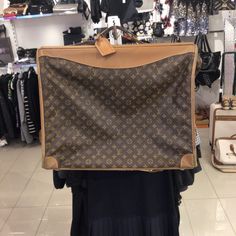 Large Brown Louis Vuitton Hanging Bag Designer Rectangular Travel Bag For Shopping, Designer Travel Bag With Leather Handles For Shopping, Designer Travel Bag With Removable Pouch For Shopping, Designer Shoulder Bag With Luggage Sleeve For Shopping, Designer Tote Bags With Luggage Sleeve, Rectangular Brown Luggage For Shopping, Rectangular Monogram Canvas Bag With Luggage Sleeve, Designer Rectangular Bag With Luggage Sleeve, Designer Shoulder Bag With Luggage Sleeve