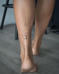 a woman's legs with tattoos on them