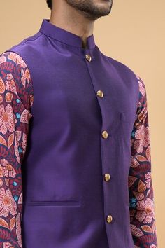 Purplish blue sleeveless solid bundi crafted in cotton silk. Paired with a gul print kurta and a white pant. - Aza Fashions Cotton Sleeveless Nehru Jacket For Festive Occasions, Transitional Sleeveless Cotton Kurta, Festive Cotton Sleeveless Nehru Jacket, Festive Sleeveless Cotton Nehru Jacket, Sleeveless Cotton Kurta, Fitted Cotton Nehru Jacket For Festivals, Kurta Set Men, White Pant, Jayanti Reddy