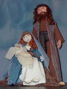 a figurine of jesus holding the baby jesus in his arms and standing next to him