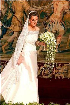 a woman in a wedding dress holding a bouquet