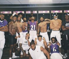 the football team is posing for a group photo in front of locker room with purple and white uniforms