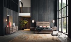 a bedroom with dark walls and wooden furniture