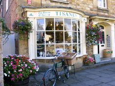 a bicycle is parked in front of a flower shop