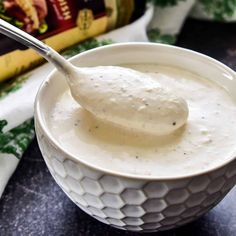 a spoon in a bowl filled with cream