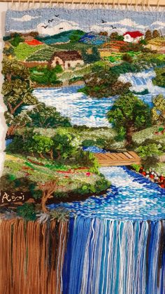 a tapestry hanging on the wall with a river running through it