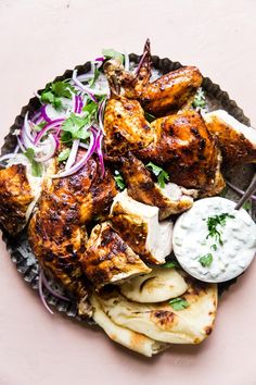 grilled chicken and vegetables on a plate with ranch dressing