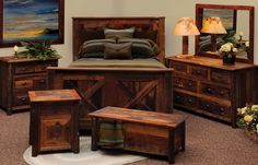 a bedroom scene with focus on the bed, dressers and nightstands that are made out of wood