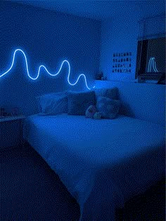 a bed in a room with blue lights on the wall