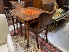 an antique chess table and chairs are on display