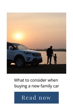 Silhouetted parent and child walking by a lake at sunset beside a parked car.