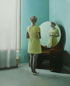 a woman standing in front of a mirror looking at herself in the mirror with her reflection