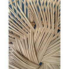 an abstract sculpture made out of bamboo sticks and wickers on a blue background