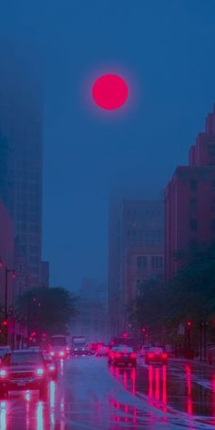 cars driving down a city street in the rain at night with red and blue lights