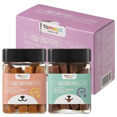 two jars filled with different types of dog treats in front of a pink cardboard box