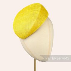 Betty is what we like to call a modern pillbox. Instead of having straight sides, this yellow hat base has a gentle slope to one side and finishes off at a slight point. It looks great positioned at many angles and is finished on the inside with a petersham ribbon edge.  Can be attached to the head with elastic, hair comb or headband (not included). Measurements: Width: 16.5x18.5cm (6.4x7.2 inches) Height at tallest ridge: 5.5cm (2.1 inches) We have hundreds of different hat bases available! To Formal Yellow Hat For Spring, Yellow Formal Hats For Royal Ascot, Yellow Summer Fascinator With Short Brim, Yellow Fascinator For Formal Royal Ascot, Spring Yellow Fascinator With Curved Brim, Spring Yellow Curved Brim Fascinator, Yellow Mini Hat With Short Brim For Kentucky Derby, Adjustable Yellow Hats For Royal Ascot, Yellow Brimmed Fitted Fascinator