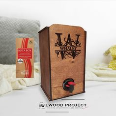 a wooden project box sitting on top of a bed next to a stuffed animal toy