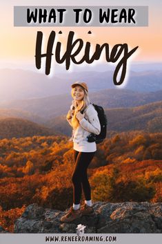 a woman standing on top of a mountain with the words, what to wear hiking