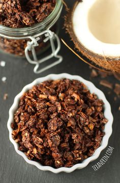 chocolate granola in a bowl next to a coconut