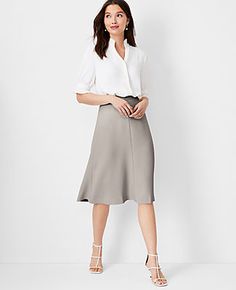 Elevate your wardrobe with the Ann Taylor Flare Skirt in Fluid Crepe, a piece that perfectly marries sophistication with a playful twist. This skirt, in an elegant Ivory Whisper shade, is a must-have for any fashion-forward woman.

- Size: Regular - 4
- Color: Ivory Whisper
- Material: 95% Polyester, 5% Spandex
- Length: 27 inches long, hits at knee
- Fit: Tailored fit
- Closure: Hidden back zipper with hook-and-eye
- Care: Machine washable
- Gender: Female
- Age Group: Adult

Designed for a sea Elegant Full Skirt In Fit And Flare Style, Elegant A-line Fit And Flare Skirt, Suit Skirts, Ivory Skirt, The Flare, Knitted Suit, Line Skirt, Business Casual Outfits, Crepe Fabric