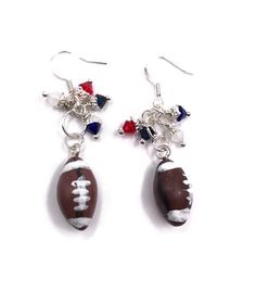 Show your team spirit with these fun football earrings!  Football charms were hand sculpted with Cernit and Premo polymer clay.  Charms hang from shiny silver-toned earring hooks accompanied by gorgeous Swarovski crystal beads in your favorite team colors. These particular earrings come with royal blue, red, white, navy blue Swarovski Crystal bicones.  Swarovski Crystal beads are no longer being sold to the public, which makes these earrings even more special!  If these colors represent your fav Gifts For Football Fans, Blue Football, Swarovski Crystal Beads, Earrings Inspiration, Swarovski Crystal Earrings, Swarovski Earrings, Clay Charms