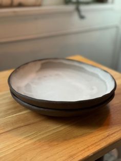 a bowl sitting on top of a wooden table