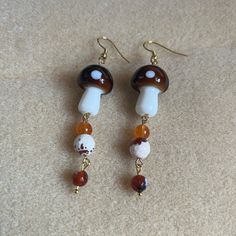 - Dangly Earrings Featuring Brown/White Mushroom Shaped Beads, Brown/White Round Glass Beads , And Orange Semi-Precious Beads - Handmade (By Myself) And Packaged With An Earring Card, Wrapped In A Cellophane Bagperfect For Gifts! -Beads Are Glass And Semi-Precious Material - Earring Cards Are 6cm (Width) And 9cm (Length) For Size Reference - On Gold Fishhook Earring Hooks Check Out My Closet For More Handmade Jewelry Tags: Boho Earrings, Dangly Earrings, Dangle Earrings Floral Earrings, Flower, Mushroom Earrings Beads, Pearl Pendant Earrings, White Mushroom, Apple Earrings, Pink Heart Earrings, Bunny Earrings, Precious Beads, Earring Card, Gold Earrings For Women