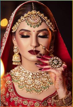 a woman with makeup and jewelry on her face