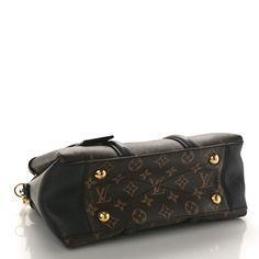 This is an authentic LOUIS VUITTON Monogram Soufflot BB in Black. This small handbag is crafted of Louis Vuitton monogram with black leather detailing. The handbag features rolled leather top handles, an optional adjustable shoulder strap, and polished gold hardware. The top is open to a partitioned black fabric interior with pockets. Leather Detailing, Small Handbag, Small Handbags, Leather Top, Authentic Louis Vuitton, Black Fabric, Gold Hardware, Louis Vuitton Monogram, Shoulder Strap