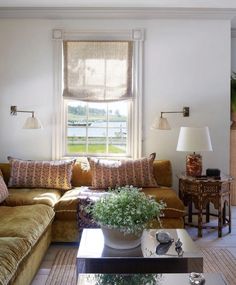 a living room filled with furniture and a large window