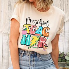 🌈 Trendy Preschool Teacher Shirt 🍎✨ Elevate your teaching wardrobe with this vibrant rainbow shirt, perfect for preschool educators! Featuring a playful apple and lightning pencil design, this trendy tee combines fun and functionality. Stand out in the classroom and inspire your little learners every day! #TeacherStyle #PreschoolTeacher #ClassroomFashion #TrendyTeacher #BackToSchool #RainbowShirt #TeacherLife #AppleDesign #LightningPencil #EduStyle #TeacherApparel #TeachingWithStyle #InspireYo Brown Pre K Shirts For Teaxhers, Rainbow Prek Shirt, First Day Of Third Grade, Teaching Wardrobe, Third Grade Teacher Shirts, Mom And Me Shirts, Preschool Teacher Shirts, Group Matching, First Grade Teacher