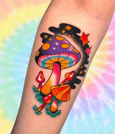 a colorful mushroom tattoo on the arm