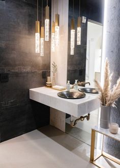 a modern bathroom with two sinks and mirrors