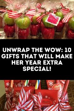 the gift basket is full of red and green apples, wrapped in plastic bags with ribbons