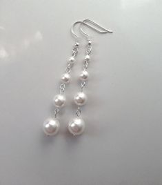 These 925 sterling silver earrings feature a beautiful drop of 4 high-end crystal pearls in varying sizes. Perfect addition to your wedding day outfit, prom, or any special occasion.  Comes in a gift box, perfect for gift-giving.  Available in white, ivory, light pink, light grey, and dark grey.  Made with 4mm, 6mm, 8mm, and 10mm Austrian crystal pearls.  Also see my pearl drop earrings made with 3 pearls: https://www.etsy.com/listing/98013860/swarovski-pearl-drop-earrings-pearl Pearl And Silver Earrings, Silver And Pearl Earrings, Silver Dangle Pearl Earrings, Prom Jewelry Silver, Dangly Pearl Earrings, Silver Prom Jewelry, Wedding Day Outfit, Hope Core, Dangle Pearl Earrings