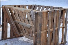 a wooden crate sitting on top of snow covered ground