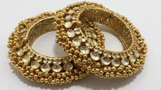 *This is Gold Finish Kundan Bangle Pair.Its Perfect for Wedding Occasion and is Unique and Ethnic Traditional Bangle to gift and also Bridal wear to match with Wedding Outfits. * Its made from Silver and Copper mix material and is 100% Handmade. * Its available in Various Sizes like 2,2.2,2.4,2.6 Etc.Its a combination of white kundan as shown in picture. *Its openable and Screwed Bangle Pair. *All Kundan stones set with silver foils handsetting method and long last guarantee of its workmanship.M Luxury Traditional Kundan Bracelets, Wedding Meenakari Toe Ring Jewelry, Kundan Toe Ring Jewelry For Weddings, Gold Hand Set Bridal Accessories For Marriage, Gold Bridal Accessories With Intricate Design For Marriage, Festive Bohemian Bracelet For Weddings, Traditional Hand Set Bangle For Wedding, Bohemian Gold Bangle For Wedding, Traditional Gold Chandbali Bridal Accessories