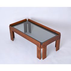 a wooden table with glass top and two legs on the bottom, against a white background